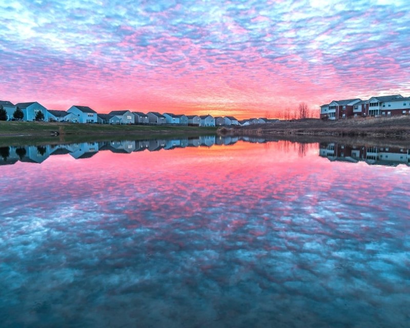 colorful sunset over an Indy suburb, pros and cons of living in Indianapolis