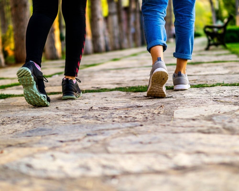 two people walking ong sidewalk, Top 5 Walkable Suburbs of Indianapolis (1)